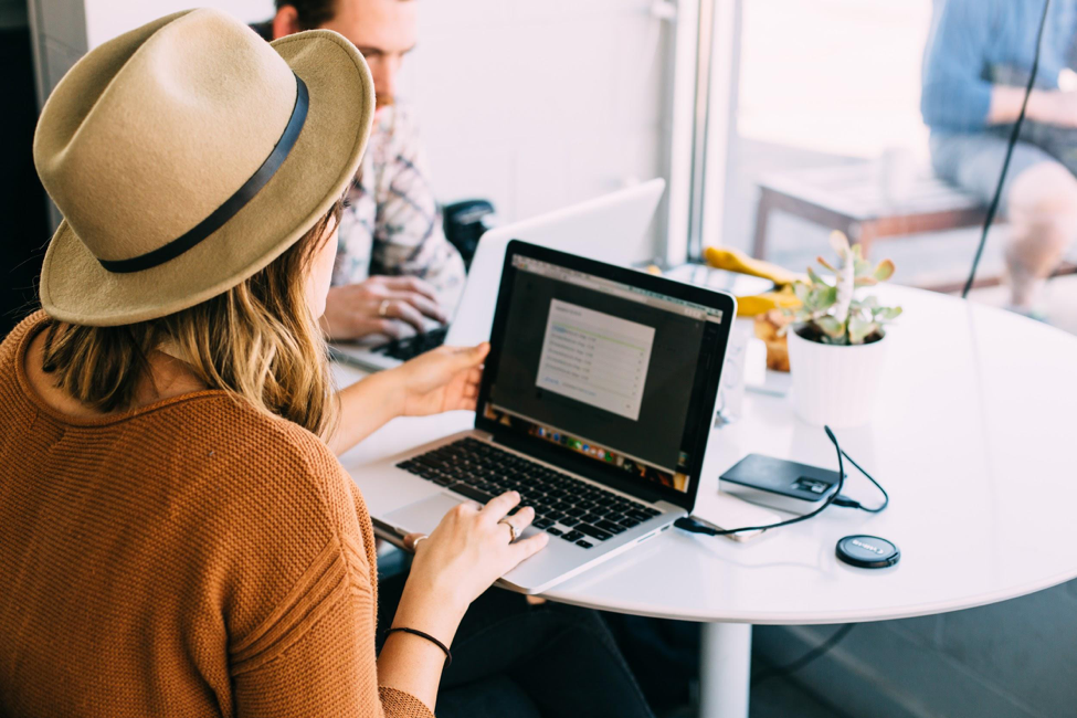 woman on laptop looking out window